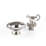 AN EARLY VICTORIAN SILVER MILK JUG, of baluster form, chased and engraved with stylised flowering