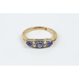 A SAPPHIRE AND DIAMOND HALF HOOP RING, millegrain set with a trio of oval and circular cabochon