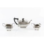 AN EDWARDIAN SILVER THREE PIECE BACHELOR'S TEA SET, with gadrooned borders and panelled bodies,