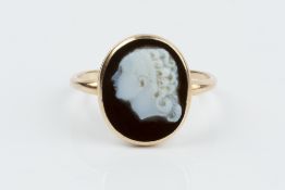 A 19TH CENTURY HARDSTONE CAMEO RING, the oval cameo carved to depict a female portrait profile, in