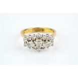 A DIAMOND CLUSTER RING, centred with a trio of pear-shaped brilliant-cut diamonds in claw