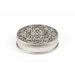 A VICTORIAN SILVER OVAL SNUFF BOX, the hinged cover with pierced stylised foliate overlay, having