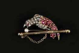 A LATE VICTORIAN DIAMOND AND VARI GEM-SET BIRD BROOCH, modelled as a parrot perched on a branch, his
