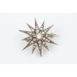 A DIAMOND STAR BROOCH, the principal old-cut diamond bordered by graduated old, single and rose-
