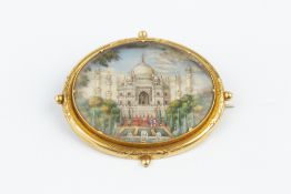 A 19TH CENTURY MINIATURE BROOCH, the oval panel painted to depict the Taj Mahal, possibly on