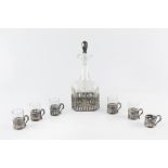 A CONTINENTAL EARLY 20TH CENTURY SILVER MOUNTED GLASS LIQUEUR DECANTER, with six matching glass