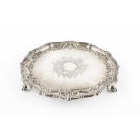 AN EDWARDIAN SILVER SALVER, with shaped, beaded and scroll embossed border, on claw feet, by Martin,