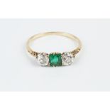 AN EMERALD AND DIAMOND THREE STONE RING, the square step-cut emerald claw set between two old