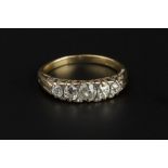 A DIAMOND FIVE STONE RING, the graduated cushion-shaped old-cut diamonds spaced by pairs of lasque-
