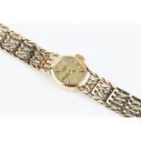 A LADY'S 9CT GOLD BRACELET WATCH BY ROTARY, the oval gilt dial with baton markers, to a jewelled