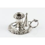 A GEORGE IV SILVER SMALL CHAMBERSTICK, with shaped foliate and scroll border, and reeded loop handle