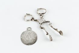 A PAIR OF 18TH CENTURY SILVER SUGAR NIPS, with scalloped grips, maker's mark struck twice W.H.