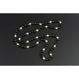 A BLACK ONYX BEAD AND CULTURED PEARL SINGLE STRAND NECKLACE BY TIFFANY & CO., with polished bead