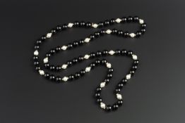 A BLACK ONYX BEAD AND CULTURED PEARL SINGLE STRAND NECKLACE BY TIFFANY & CO., with polished bead