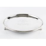 A SILVER CIRCULAR SALVER, with reeded border, on shaped feet, presentation inscriptions, by