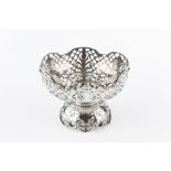 AN EDWARDIAN SILVER BOWL, pierce decorated with urns, foliage and lattice work, on similar domed