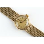 A LADY'S 9CT GOLD BRACELET WATCH BY OMEGA, the circular dial with baton markers, to a jewelled