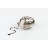 A LATE VICTORIAN SILVER EGG SHAPED TEA INFUSER, with floral and foliate engraved decoration, maker's
