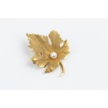 A CULTURED PEARL SET BROOCH BY TIFFANY & CO, modelled as a maple leaf, with single cultured pearl