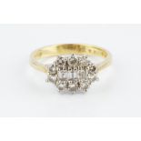 A DIAMOND CLUSTER RING, centred with a trio of rectangular step-cut diamonds, bordered by round