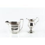 A GEORGE III SILVER CREAM JUG, with punched border, baluster body and circular pedestal foot,