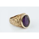 AN AMETHYST SINGLE STONE RING, the oval mixed-cut amethyst collet set to a tapered hoop with