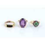 THREE DRESS RINGS, comprising an emerald and ruby cluster ring, stamped '18ct', an amethyst single