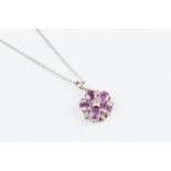 A DIAMOND AND GEM SET PENDANT ON CHAIN, designed as a flowerhead cluster of graduated round