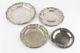A GERMAN SILVER PLATE, with shaped border, 30.5cm diameter; two matching slightly smaller plates,