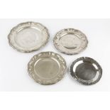 A GERMAN SILVER PLATE, with shaped border, 30.5cm diameter; two matching slightly smaller plates,