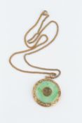 A JADE ANNULAR PENDANT ON CHAIN, the circular jadeite panel centred with an oriental character