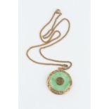 A JADE ANNULAR PENDANT ON CHAIN, the circular jadeite panel centred with an oriental character