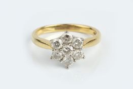 A DIAMOND CLUSTER RING, designed as a flowerhead cluster of round brilliant-cut diamonds, in claw