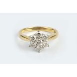 A DIAMOND CLUSTER RING, designed as a flowerhead cluster of round brilliant-cut diamonds, in claw