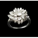 A DIAMOND COCKTAIL RING, designed as an abstract tiered cluster of graduated round brilliant,