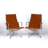 Charles Eames (1907-1978) for Vitra A pair of EA 108 swivel chairs aluminium base and orange