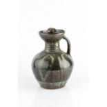 Michael Cardew (1901-1983) at Abuja Pottery Ewer the tenmoku glaze with combed decoration 23cm