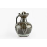 Ladi Kwali (1925-1984) at Abuja Pottery Ewer with dark glaze, and combed decoration covered in white