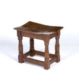 Robert Thompson of Kilburn (1876-1955) Mouseman stool, circa 1940s burr oak, raised on four carved