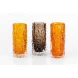 Geoffrey Baxter (1922-1995) for Whitefriars Three Bark vases two in tangerine coloured glass, the