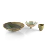 Bridget Drakeford (b.1946) Two shallow bowls and a tea bowl with green glazes and gilt highlights