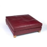 Pierre Frey, Paris Foot stool with red leather upholstery 27cm high, 123cm wide.