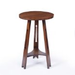 Manner of Liberty & Co. Occasional table, circa 1910 the circular top over three supports with