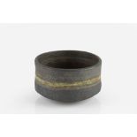 Robin Welch (1936-2019) Tea bowl stoneware, with graduated dark glaze with a band of yellow
