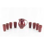 Rupert Spira (b.1960) Lemonade set comprising jug and eight beakers copper red glaze jug 19cm