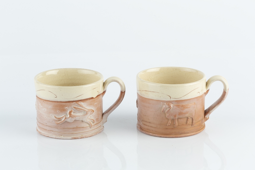 Philip Wood (b.1957) A pair of mugs moulded with animals, the rims with band of cream glaze - Image 2 of 3