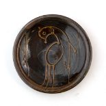 Svend Bayer (b.1946) Dish treacle glaze, decorated with a bird 25cm diameter.