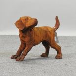 A rusted cast iron figure of a puppy,