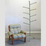 A 1970's green upholstered teak armchair, together with a hat stand,