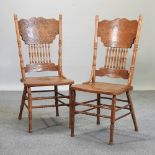 A pair of American carved spindle back chairs